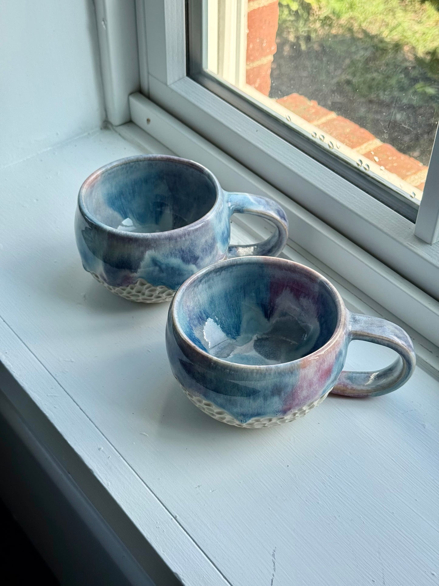a set of beautiful drippy mugs