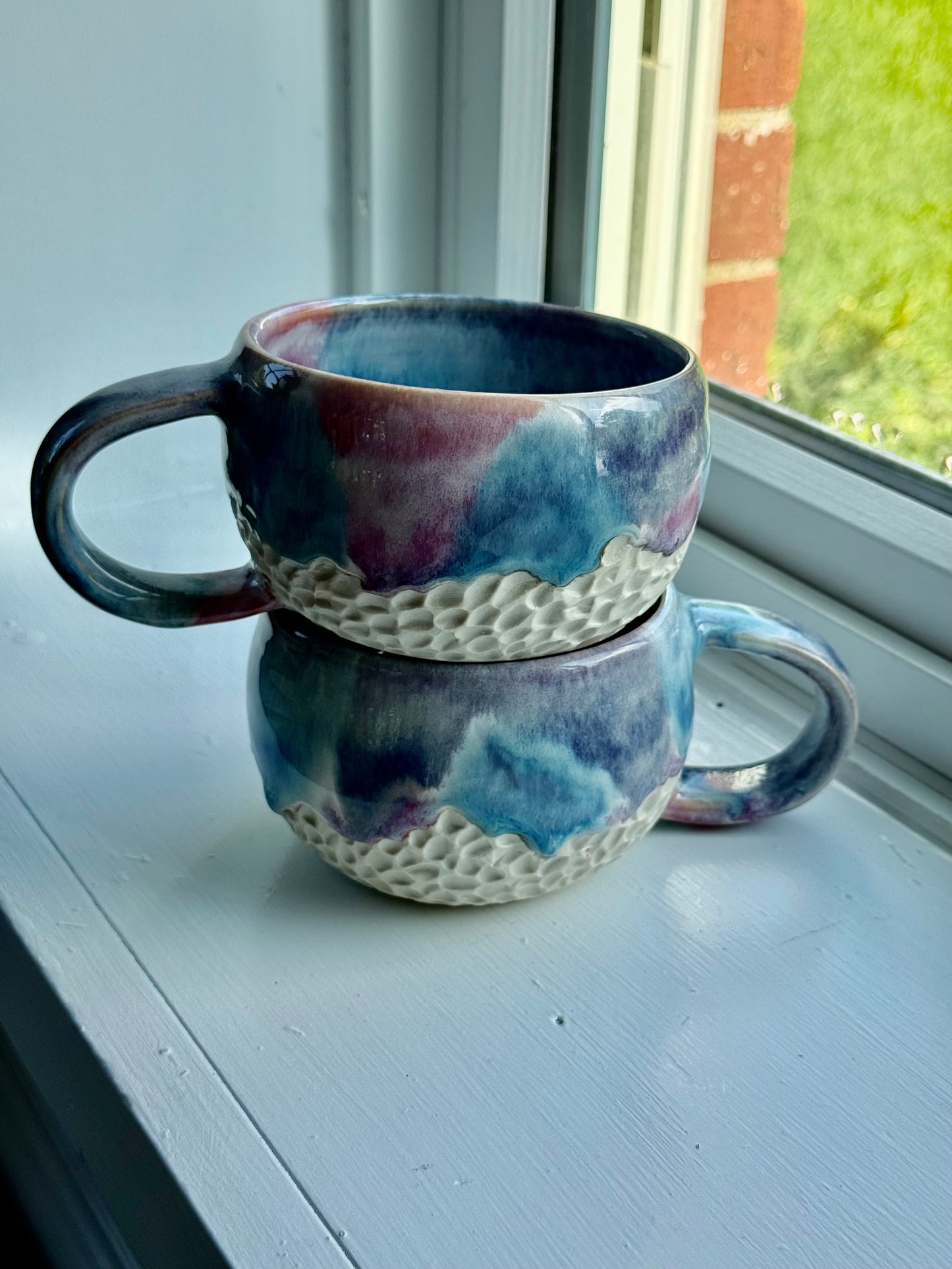 a set of beautiful drippy mugs