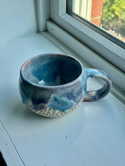a set of beautiful drippy mugs
