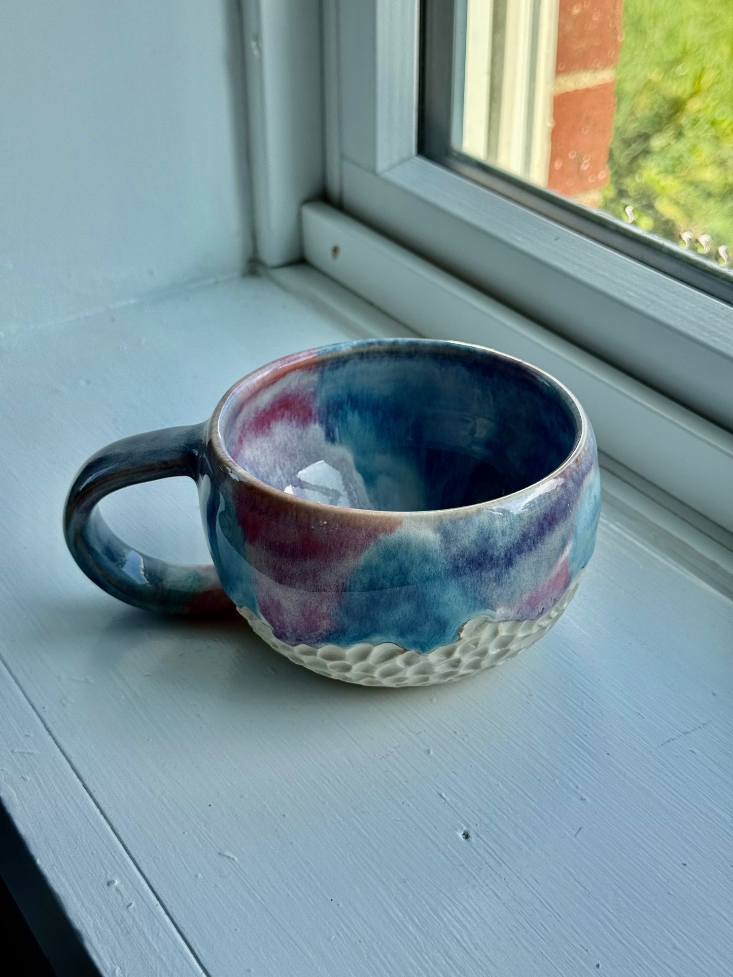 a set of beautiful drippy mugs